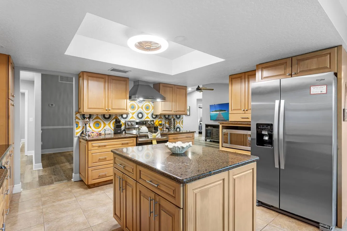 Kitchen island with refrigerator at Sarasota Beach Bungalow, Bradenton, Florida