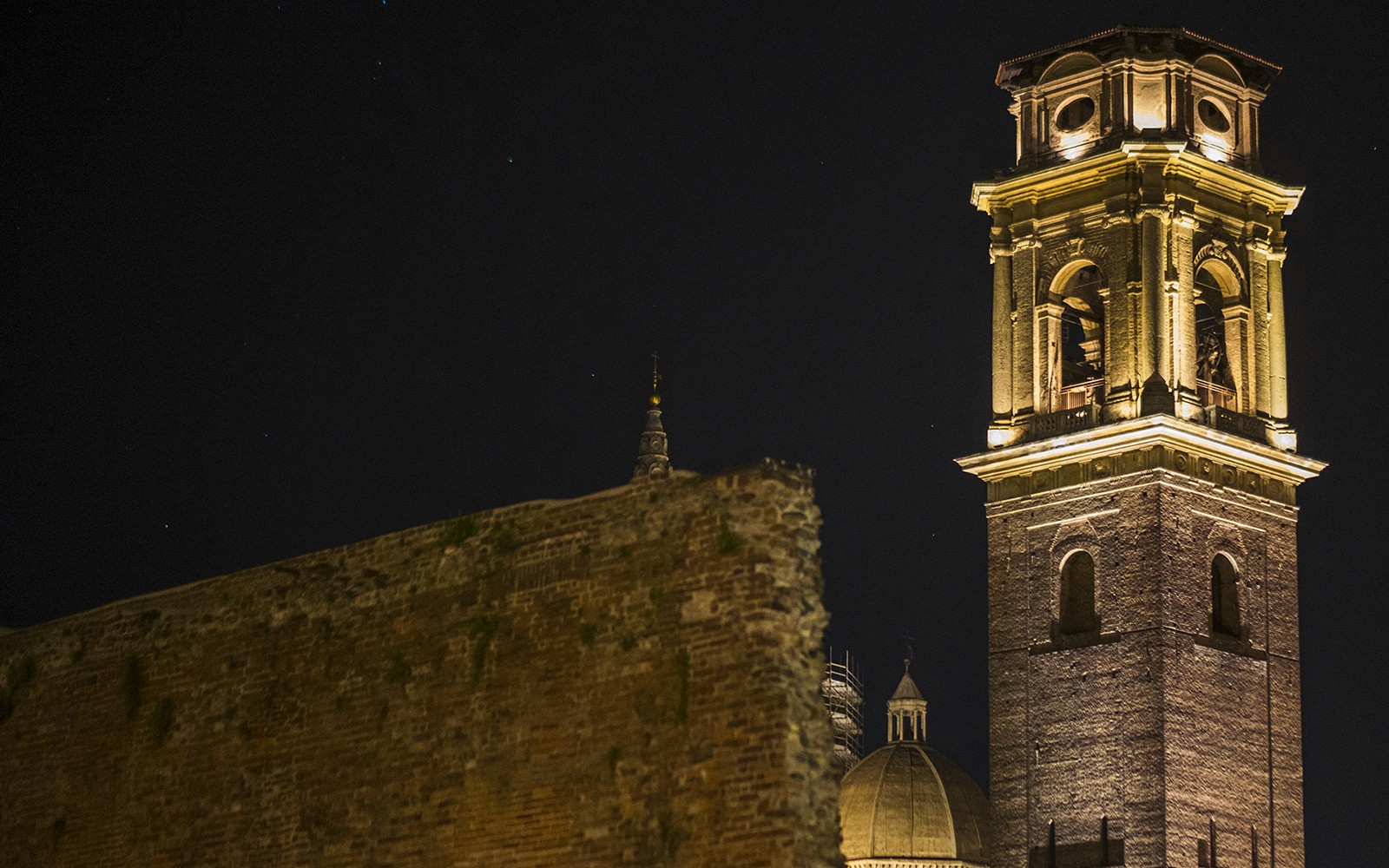 Torino bell tower illuminated at night during Italian Guided Tour.