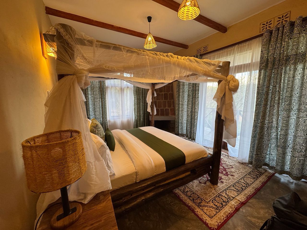 Lone acacia tree standing in the middle of AlUla’s desert plain beneath a soft blue sky.