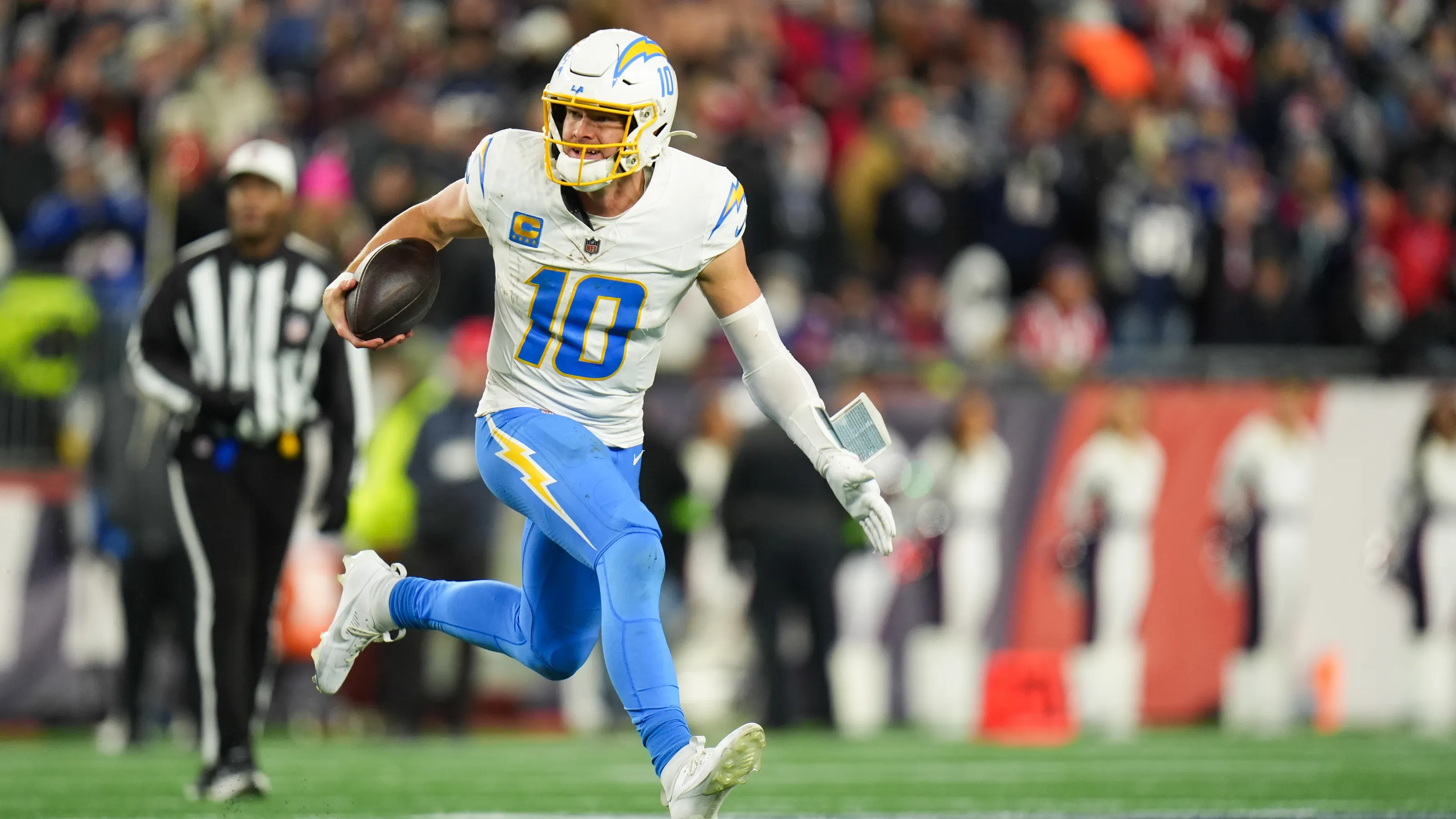 Los Angeles Chargers quarterback running with the football during an NFL game.
