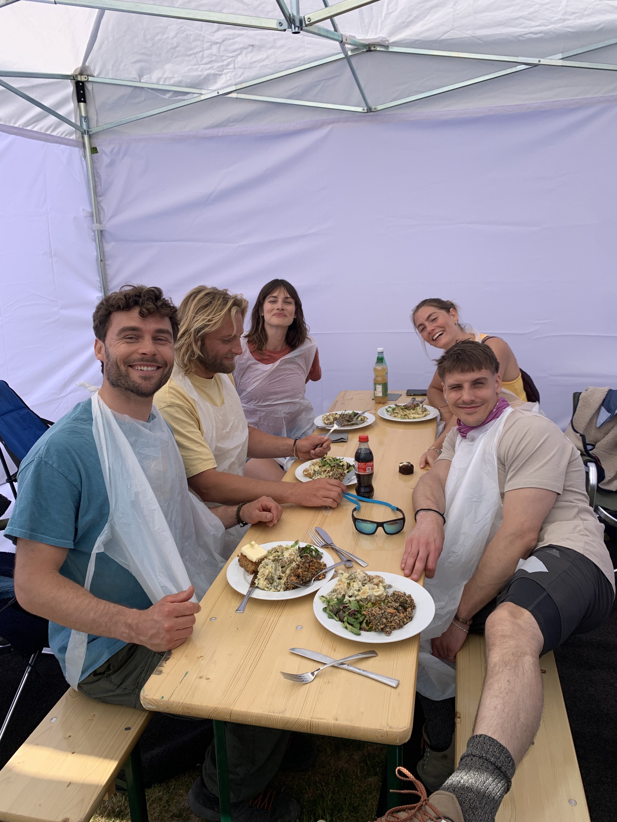 Catering tent on the Radeberger shoot: cast in costume-protection capes during a break