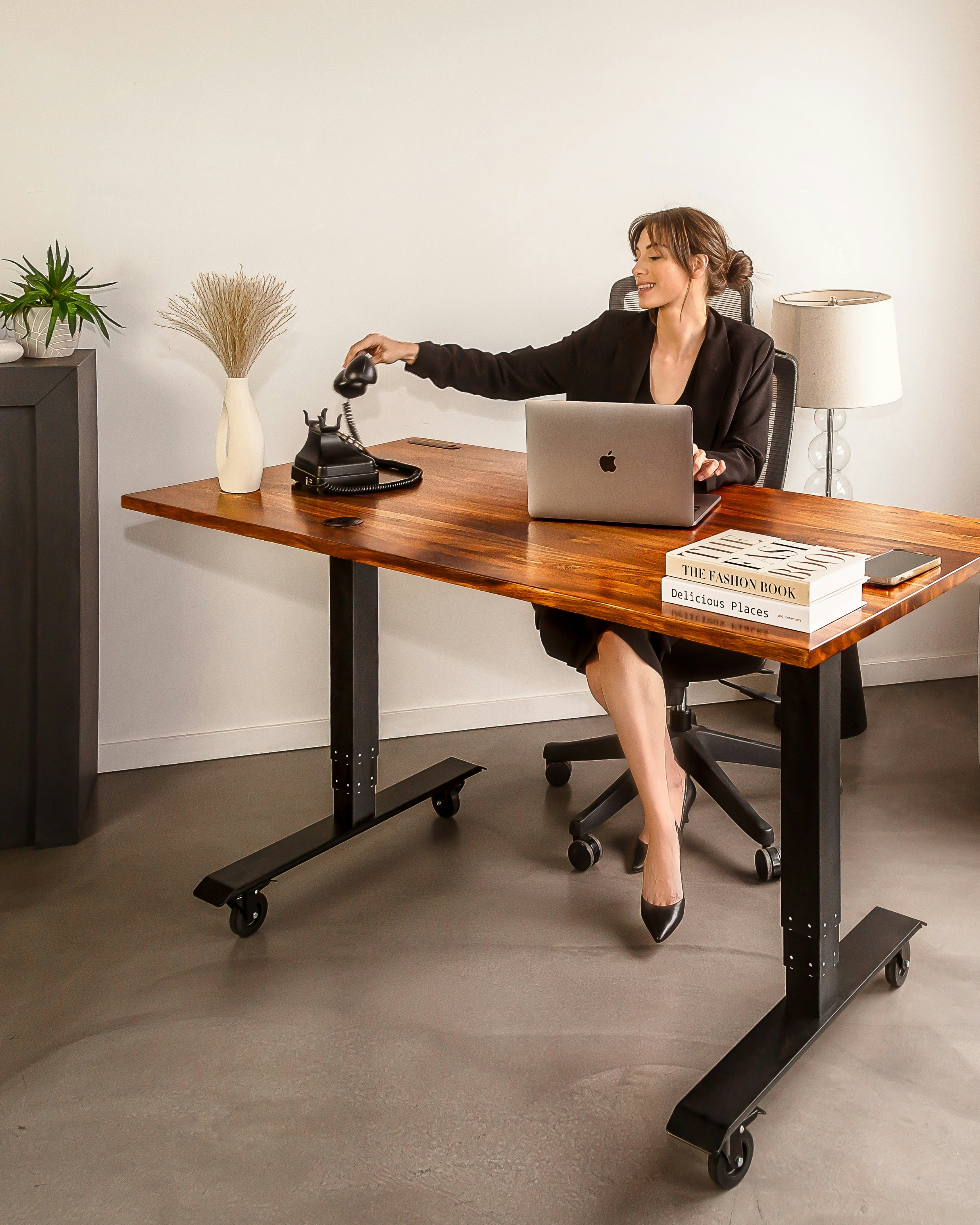 a woman sitting at a desk with a laptop