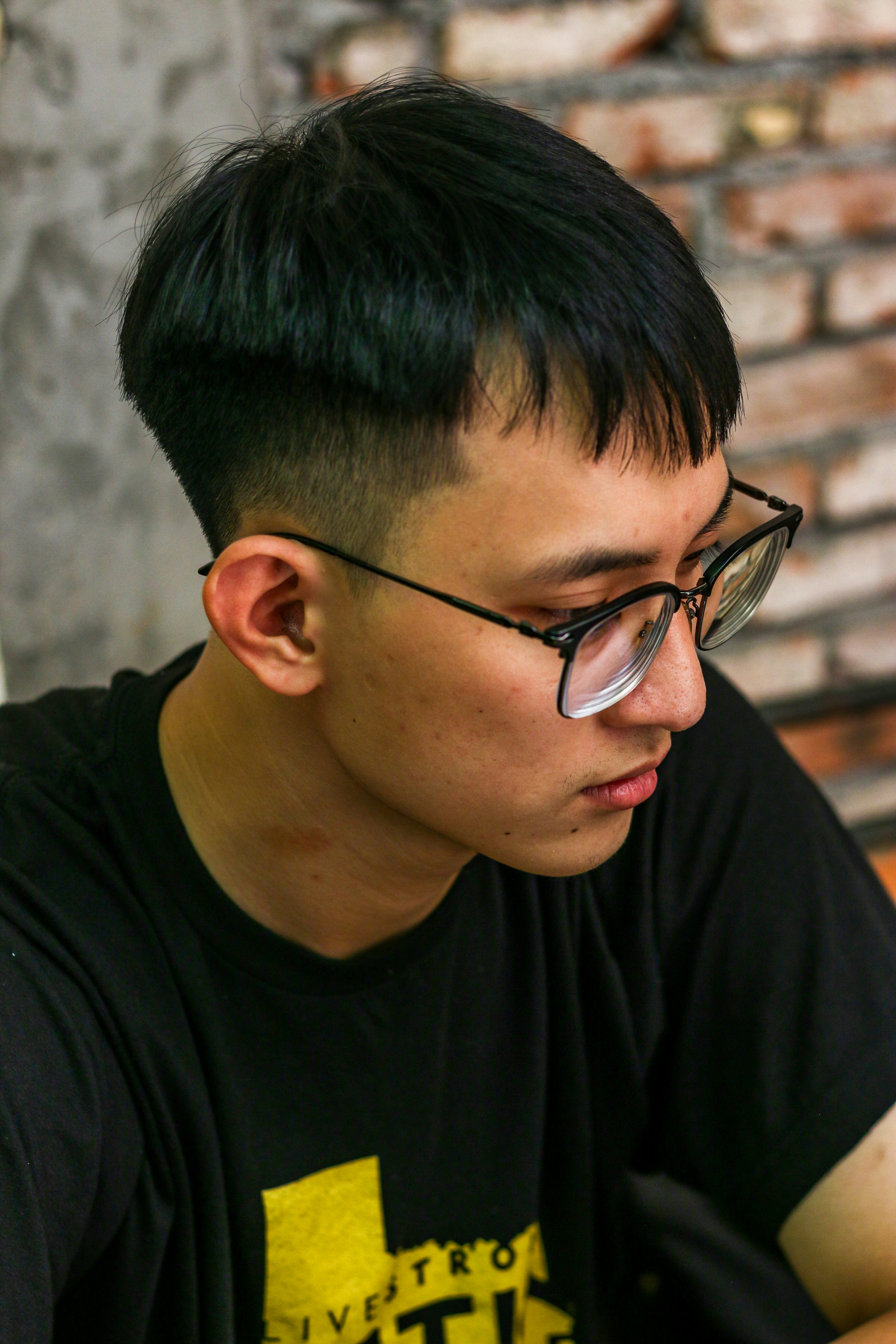 a man wearing glasses looking at his cell phone