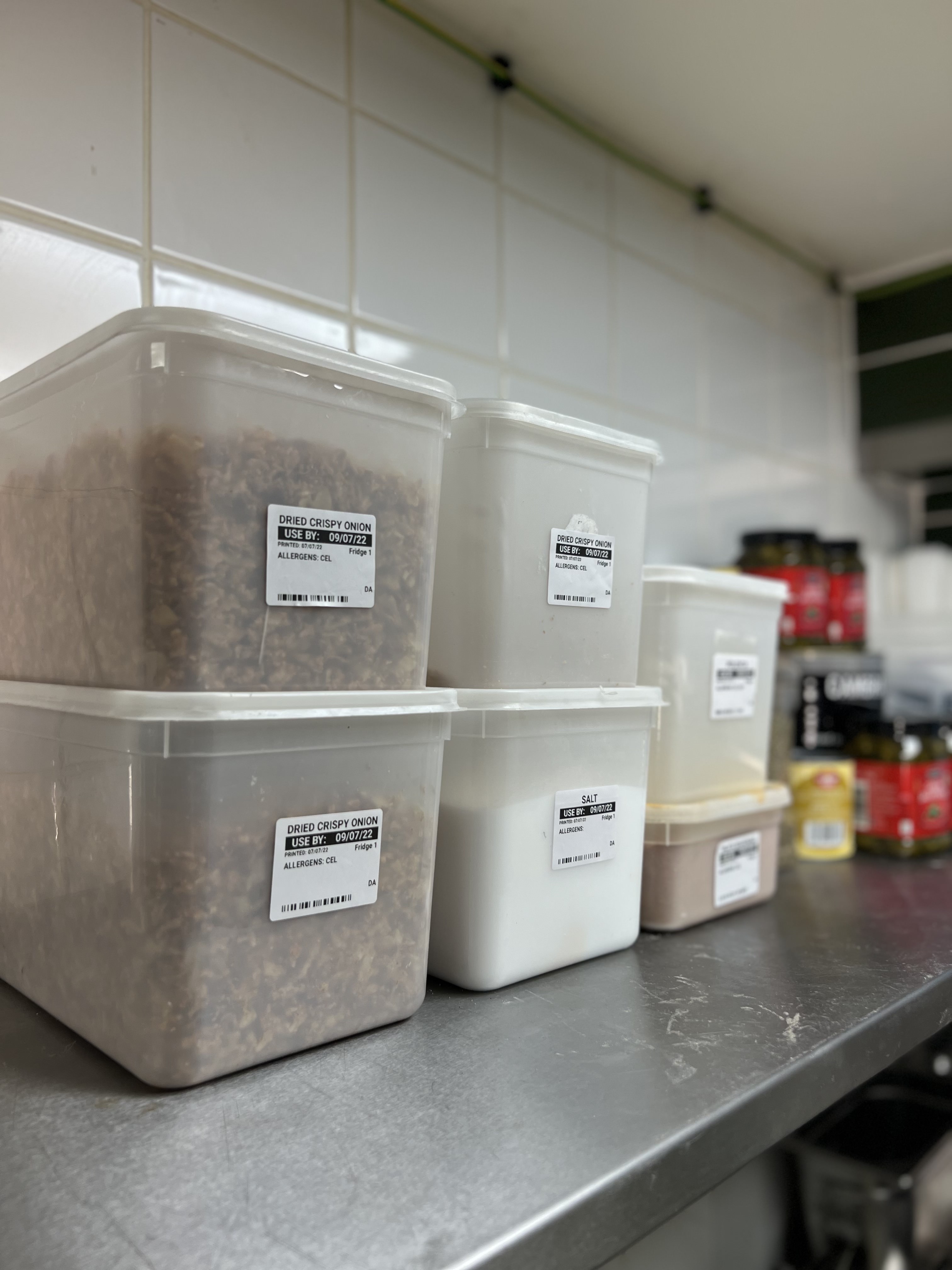 A shelf of ingredient tubs with Labl.it prep labels