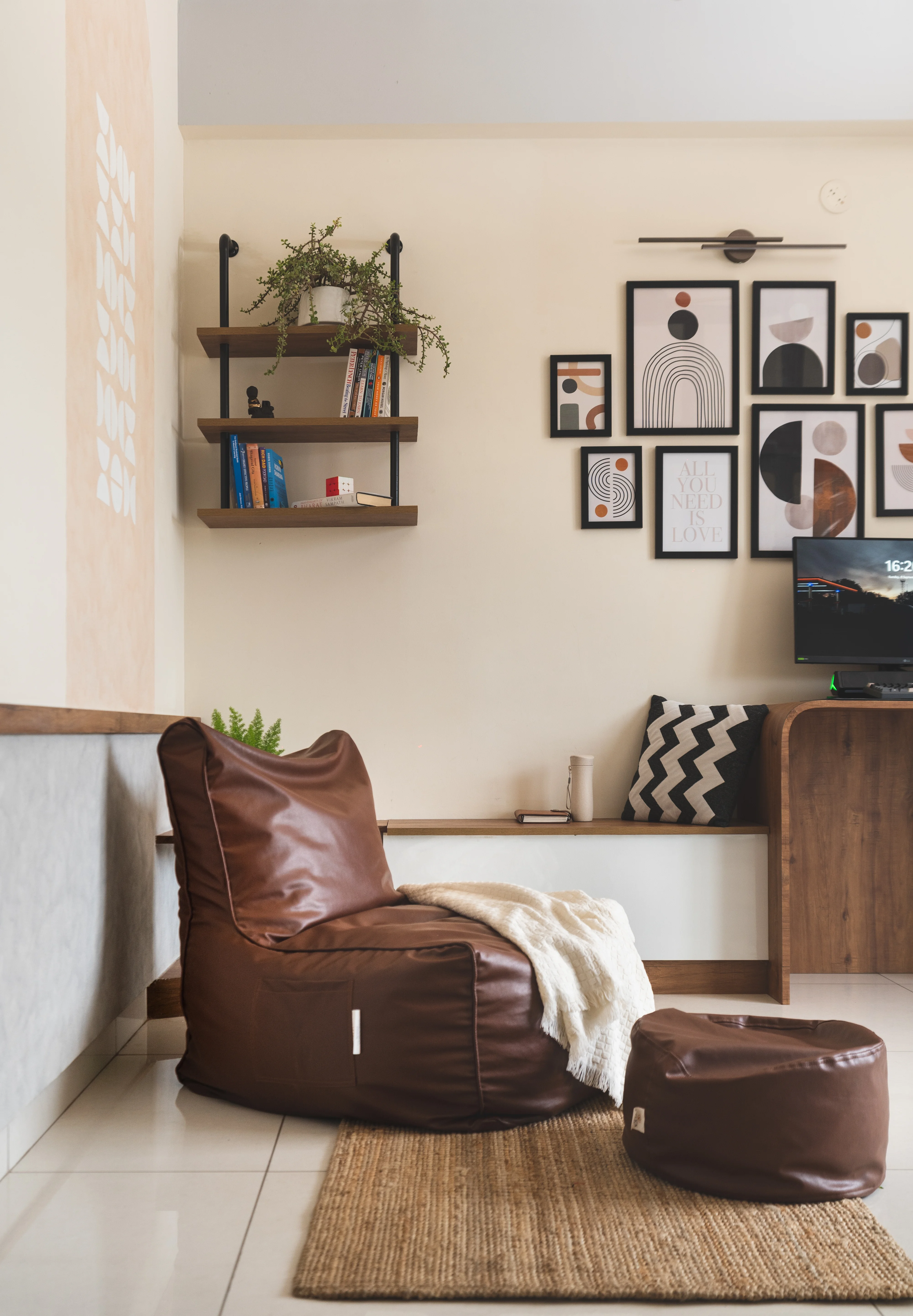 A modern study room featuring a bean bag chair and a Workstation with book shelves, designed with curves for a minimal aesthetic in South Indian homes.