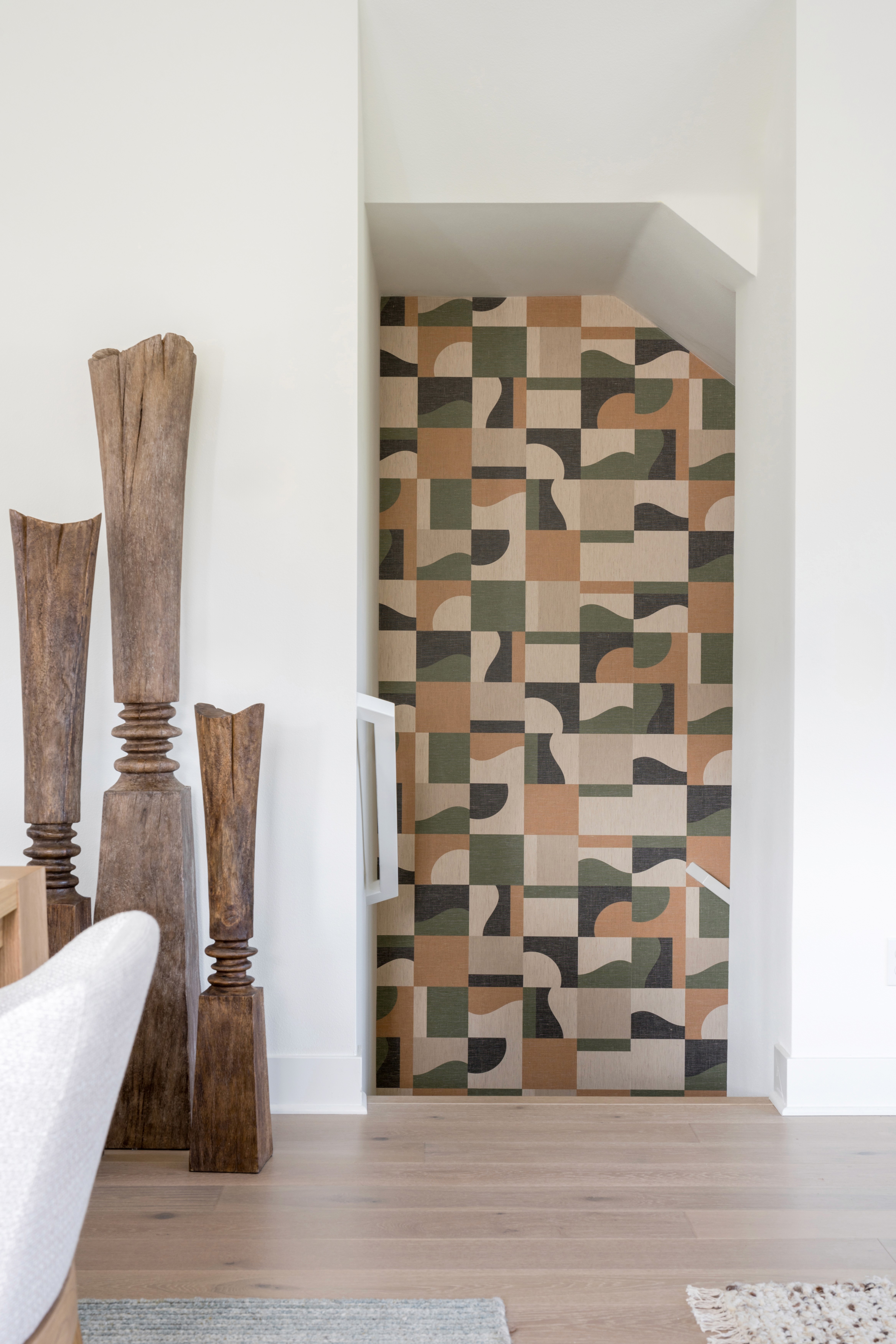 Entry to stair well with green, orange, and beige wall paper