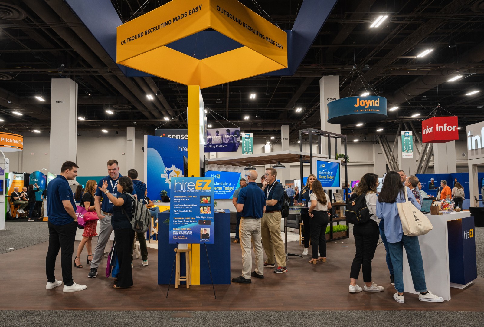 HireEZ both in HR Technology Confrences venue while members browse and service agents speak to them