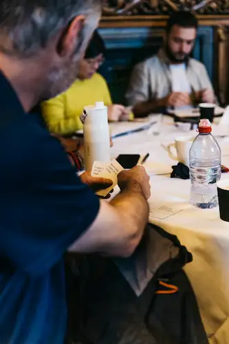 People sitting at a table with food and drinks.