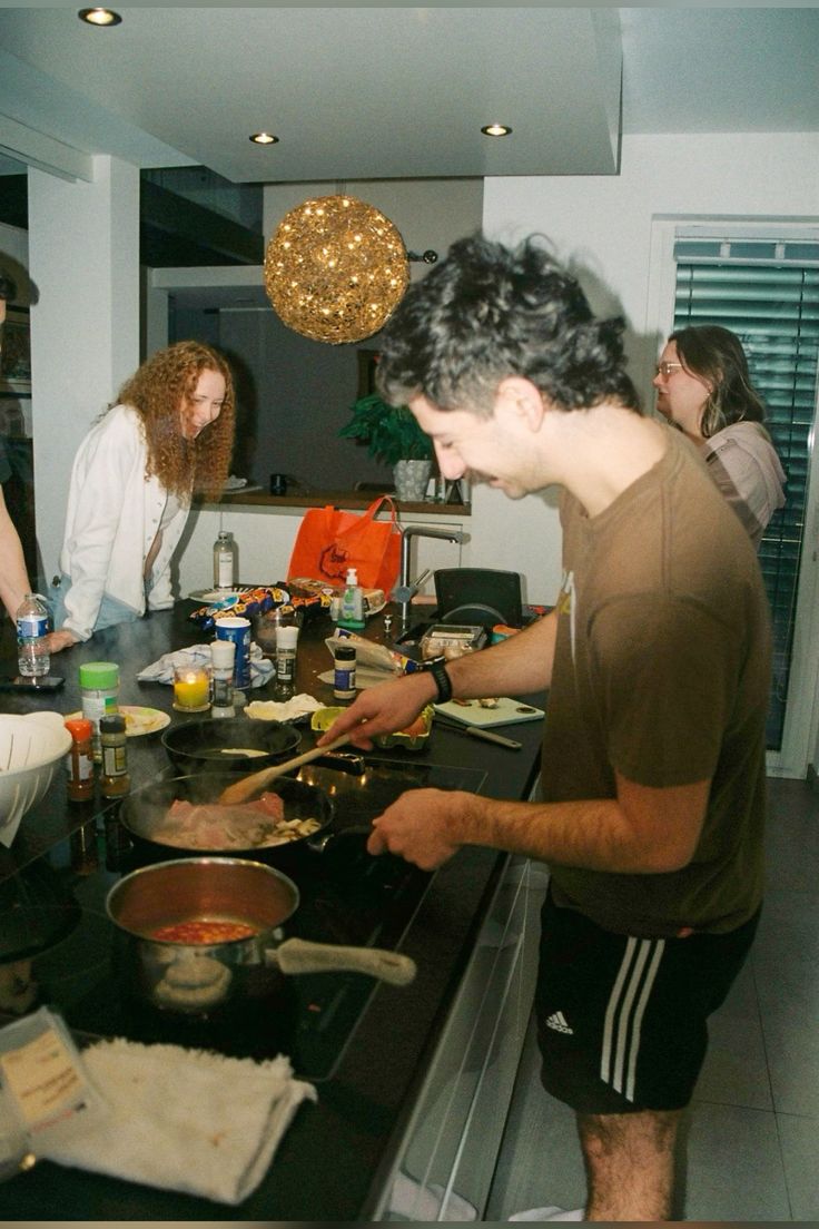 two people sitting at a table with laptops