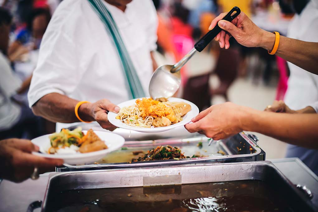 Food serving station with users having food plated up for them