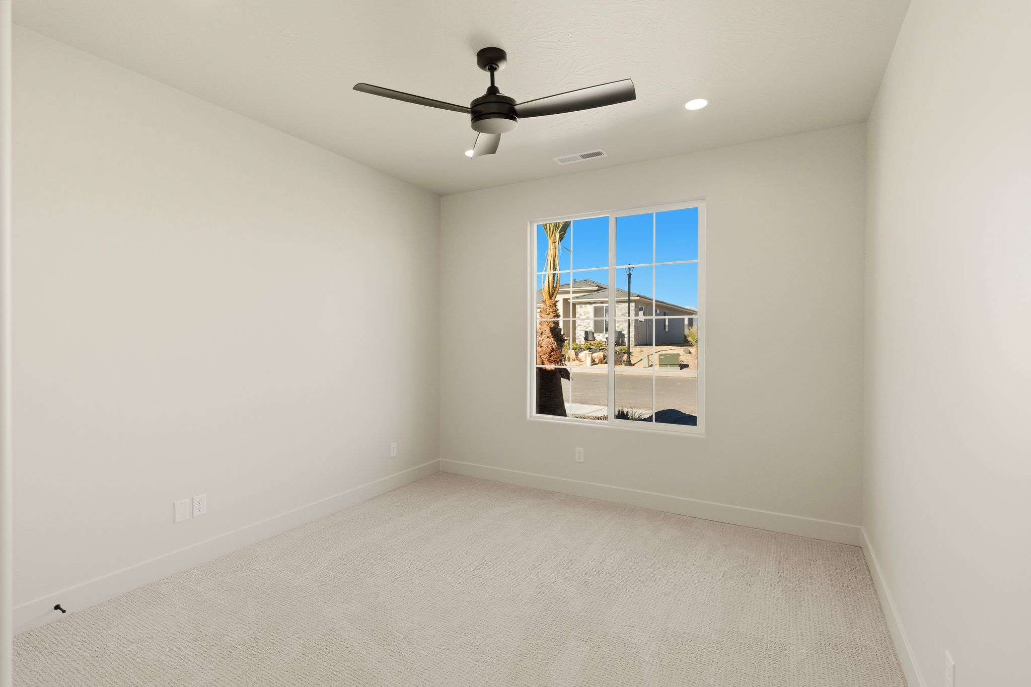 Secondary bedroom at The View at Falcon Ridge in Hurricane, Utah, with bright, airy finishes and clean design.