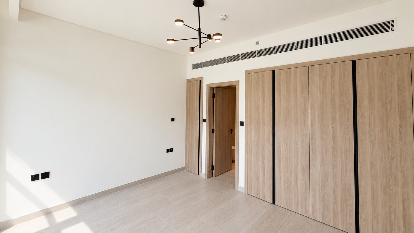 Empty bedroom on handover, fitted wardrobes and nothing else