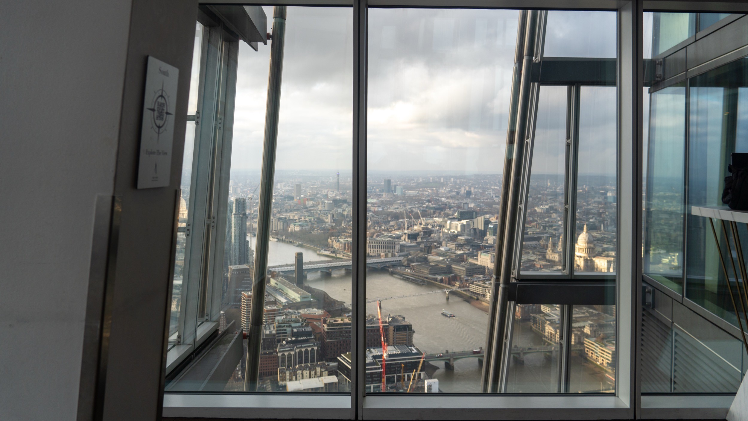 Two classic volkswagen beetles, one green, one cream.