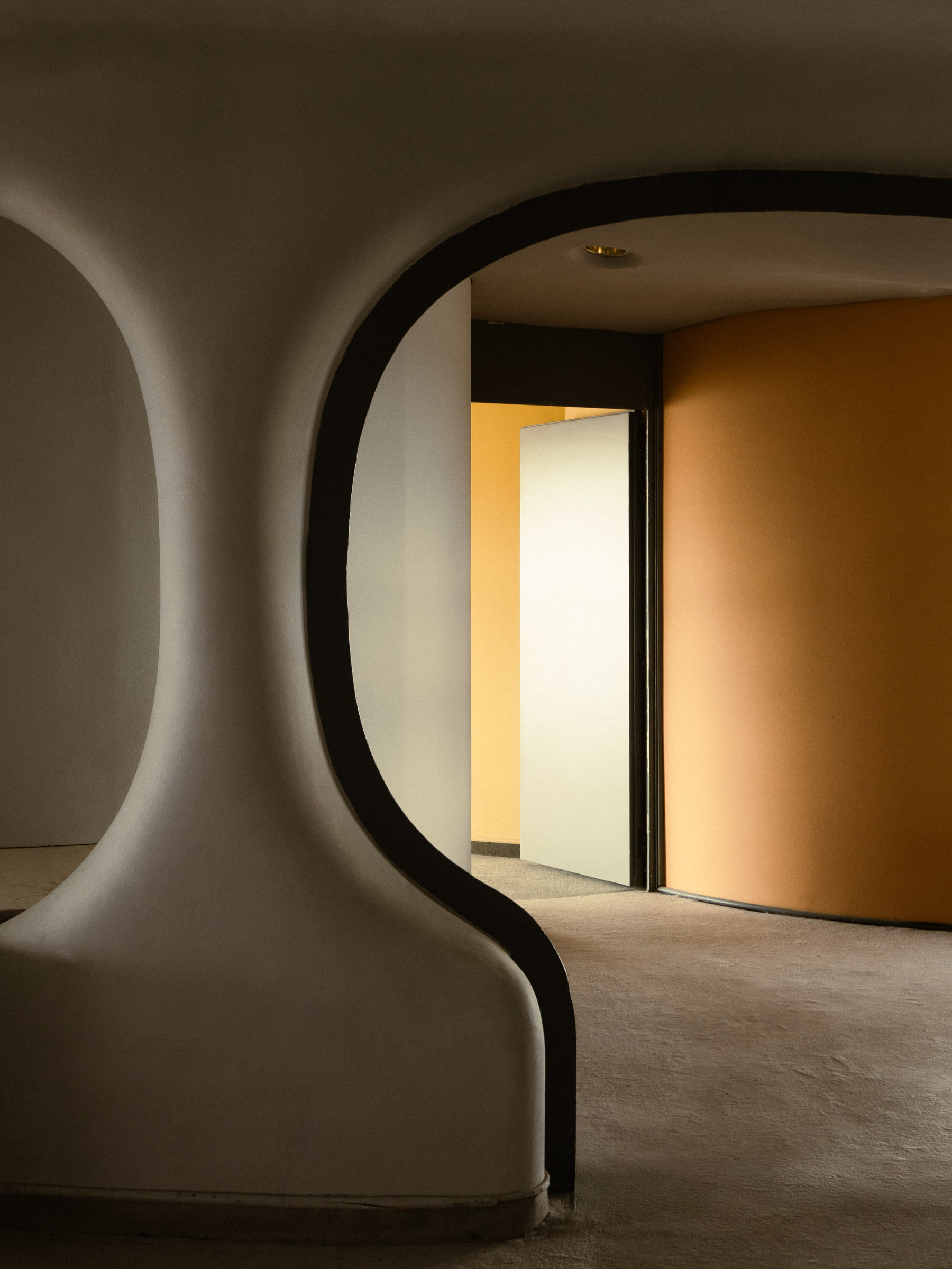 Curved architectural arch and circular doorway inside Torres Blancas in Madrid.