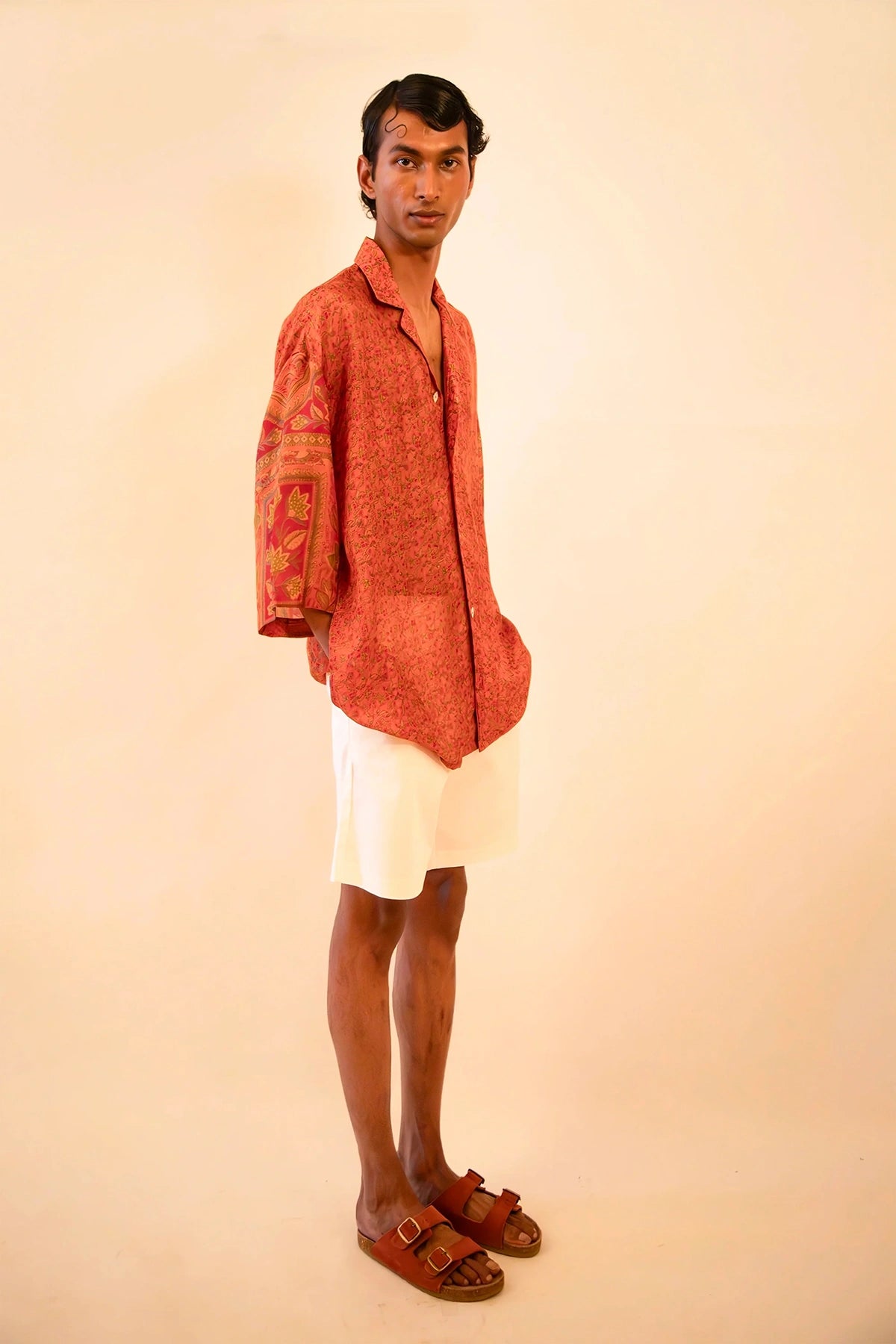 Oversized orange printed silk shirt handcrafted from a vintage sari, featuring a relaxed fit, 3/4 sleeves, soft texture, and playful button details, celebrating comfort, craft, and thoughtful design.