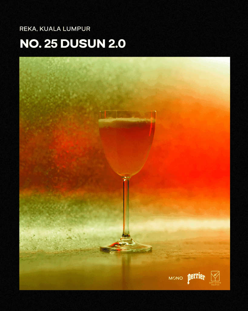 A cocktail named 'Dusun 2.0' served in a clear glass with a long stem, set against a blurred, colorful background that fades from green to orange. The image emphasizes the drink's vibrant appearance.