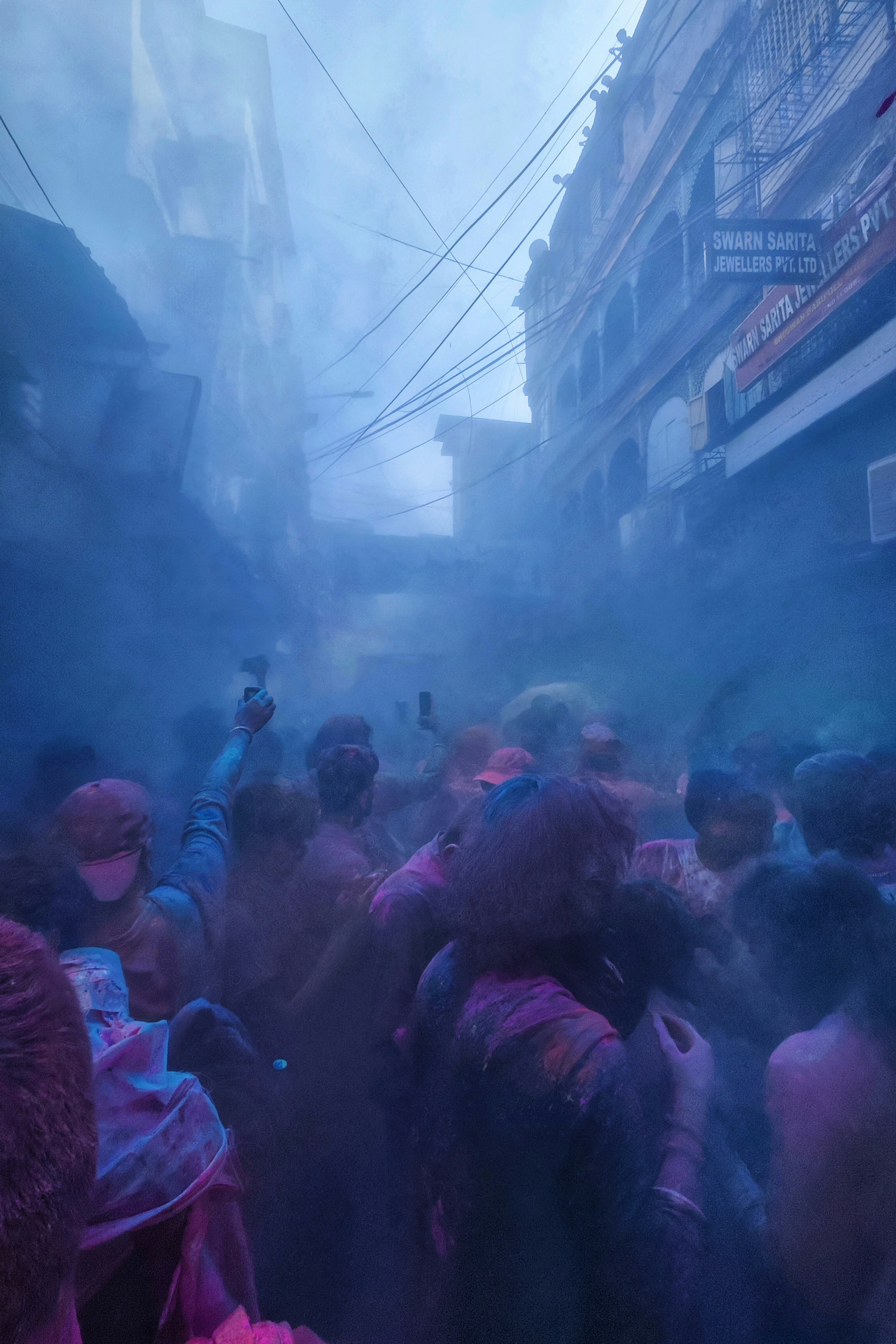 Crowd celebrating holi festival with colored powder