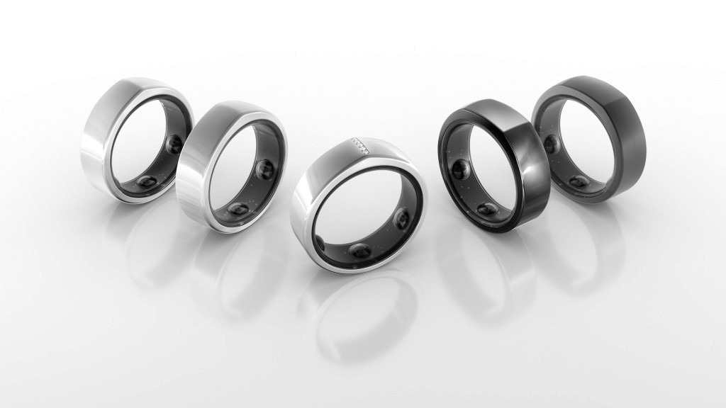 Black and white image of people working at a table with laptops, showing hands gesturing during discussion of digital content displayed on screens, with fabrica® logo in the corner.