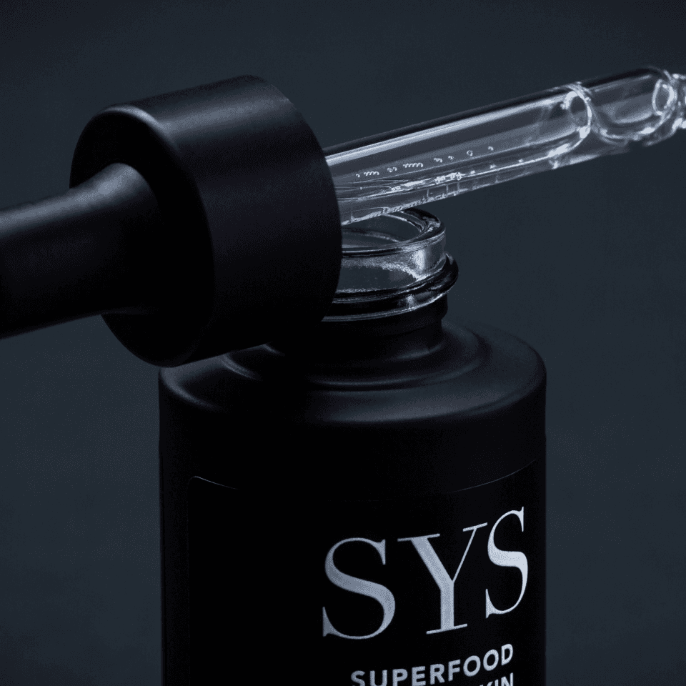 SYS Detailed View – packaging detail with black typography on pink