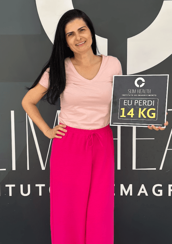 Close-up of a dark green leaf showing its textured surface and central vein against a muted background.