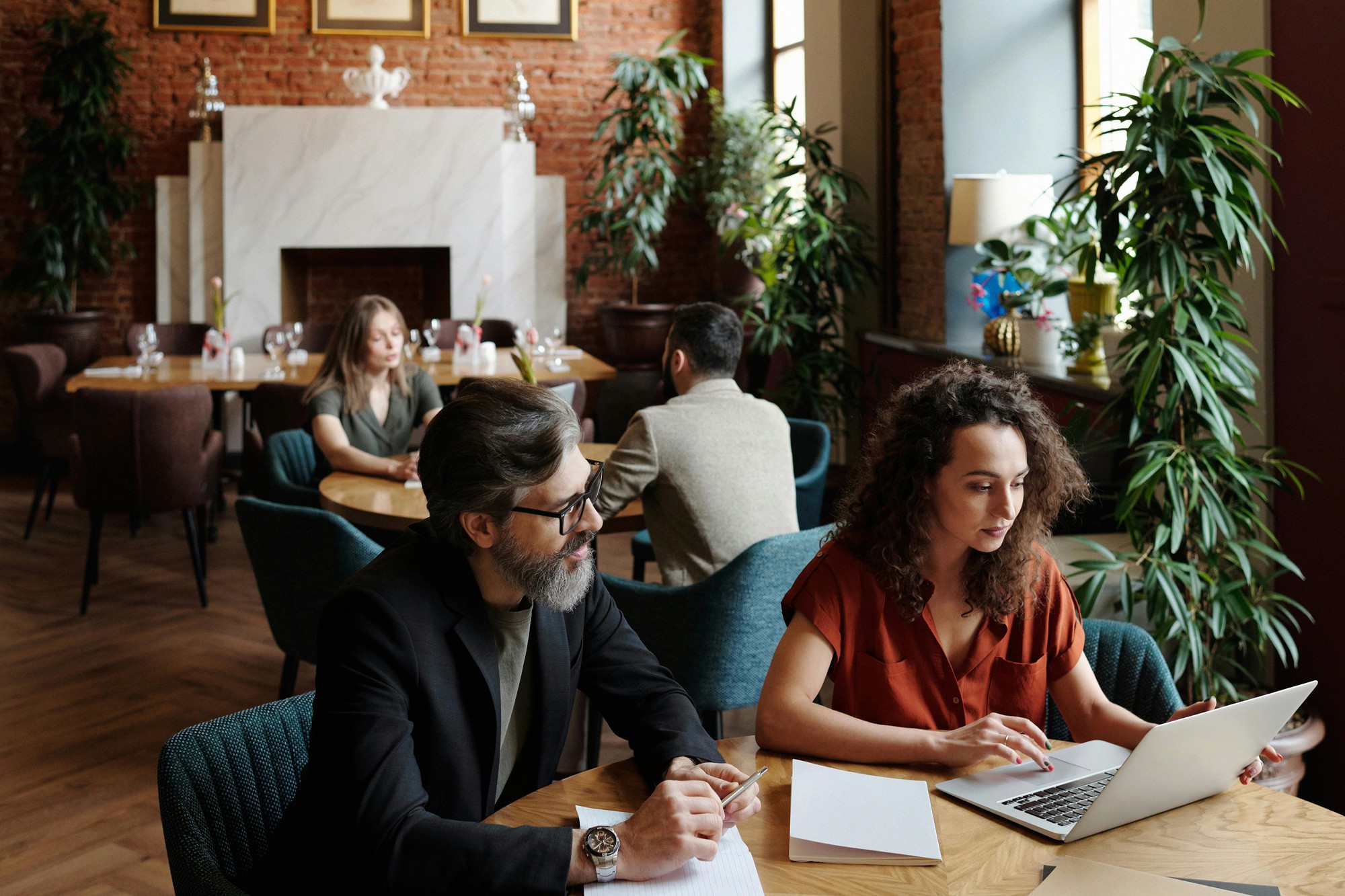 Professionals working on laptops representing streamlined user journey for small business funding applications and conversion focused website design