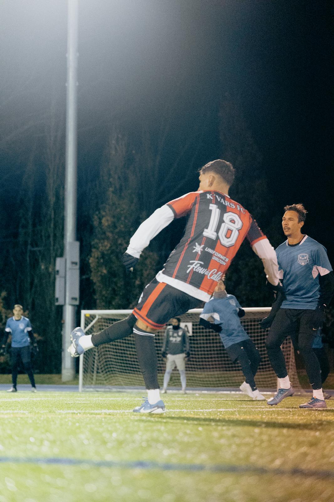 man in gray hoodie and blue denim jeans standing on brown wooden parquet flooring