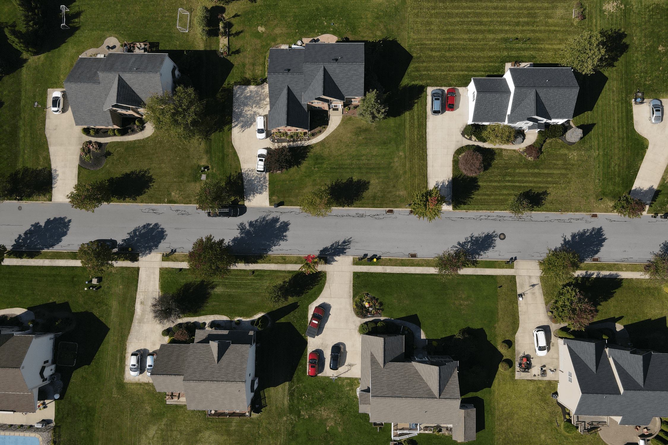 Drone shot of multiple roofs completed on the same street by KCX Roofing