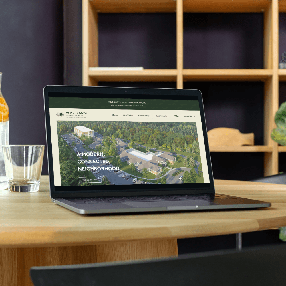 Graphic design mockup of a laptop with a website forVose Farm Residences — earthy, clean wordmark logo of a house and river with a clean sans serif typography, designed by Will Lefkovich.