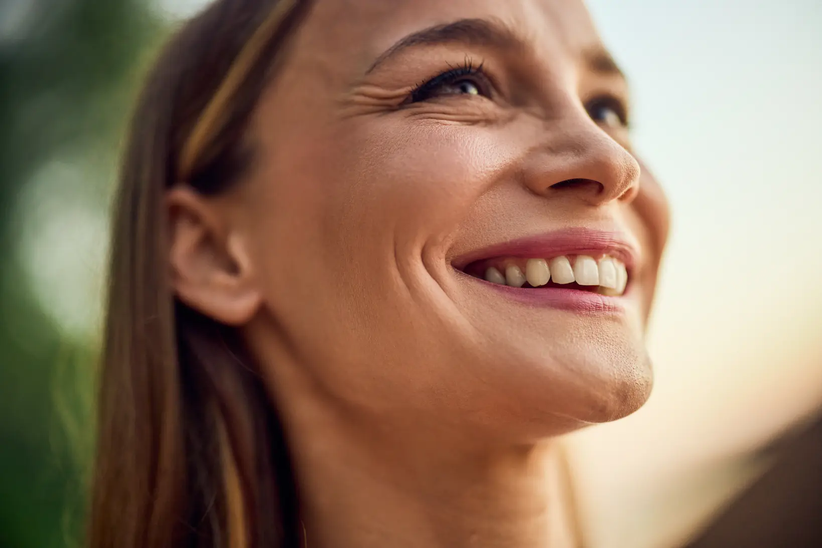 Smiling woman after microneedling treatment