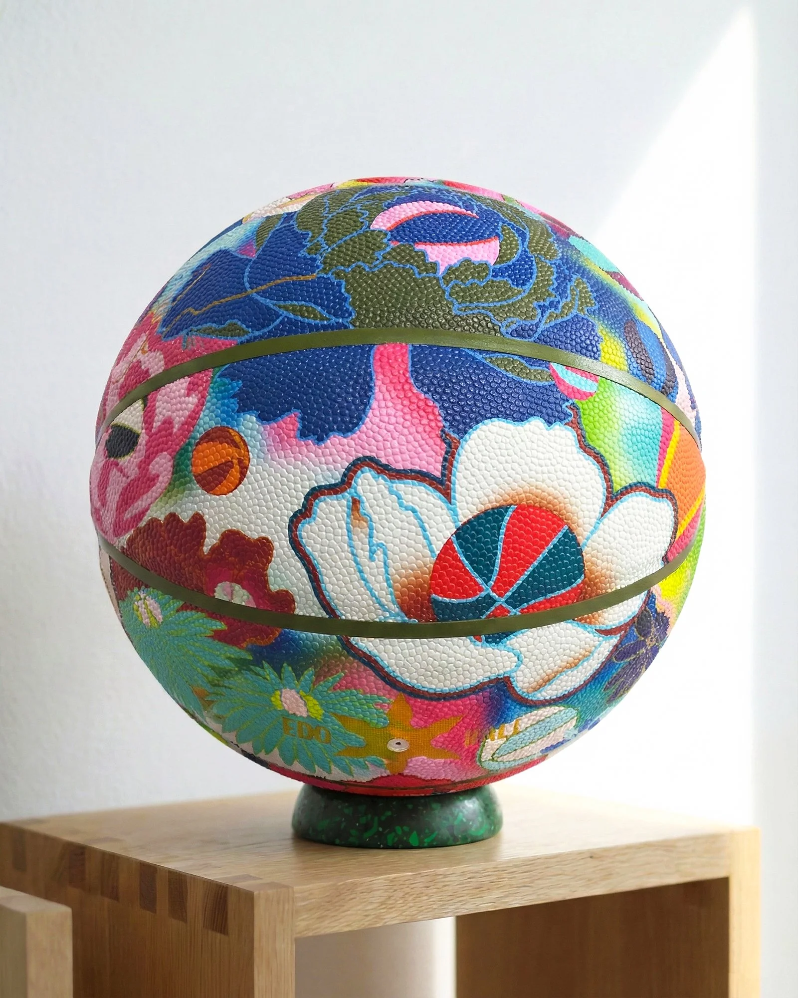 Hand-painted basketball with floral artwork created as part of The Art of Basketball collection.