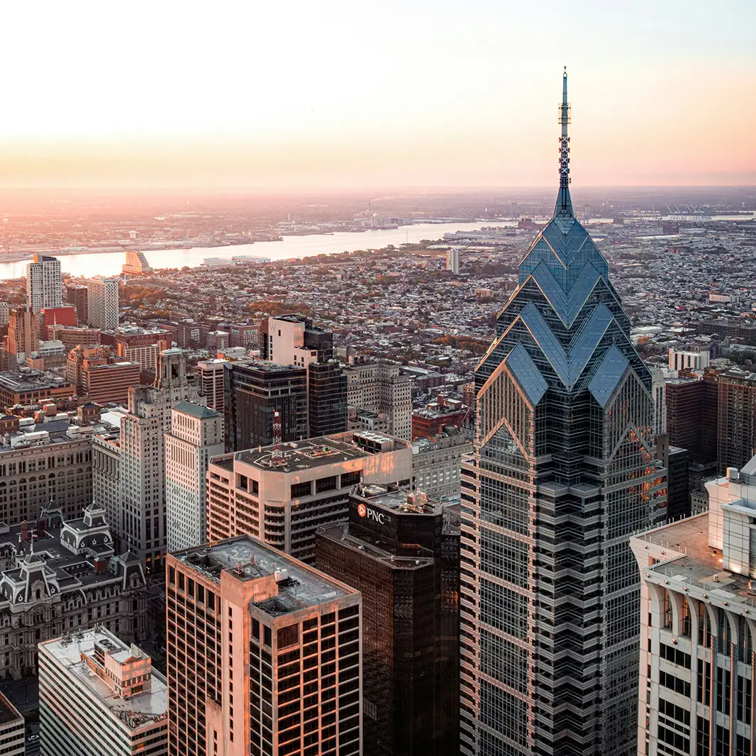 Philadelphia skyline at sunset with City Hall and Center City skyscrapers, view from Camden waterfront near Organic Farms dispensary