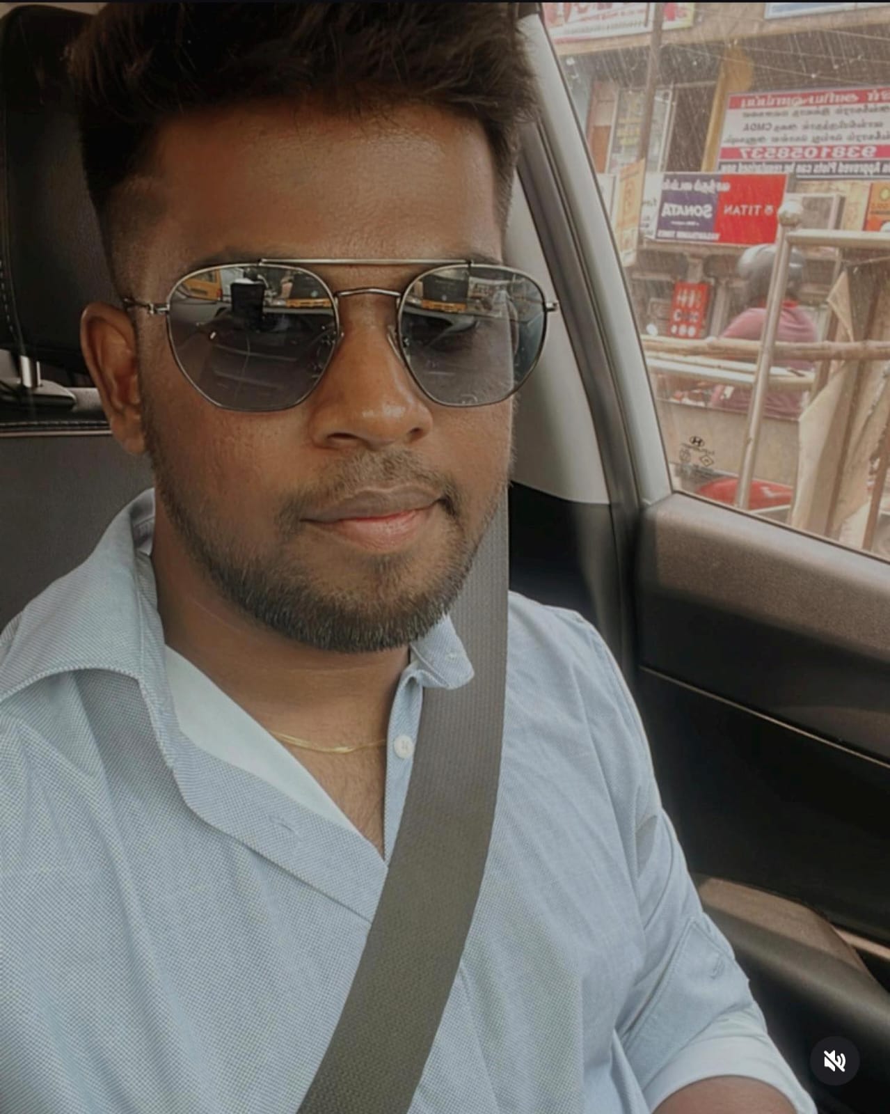 Portrait of a young man with long hair and a beard, wearing a black hoodie.