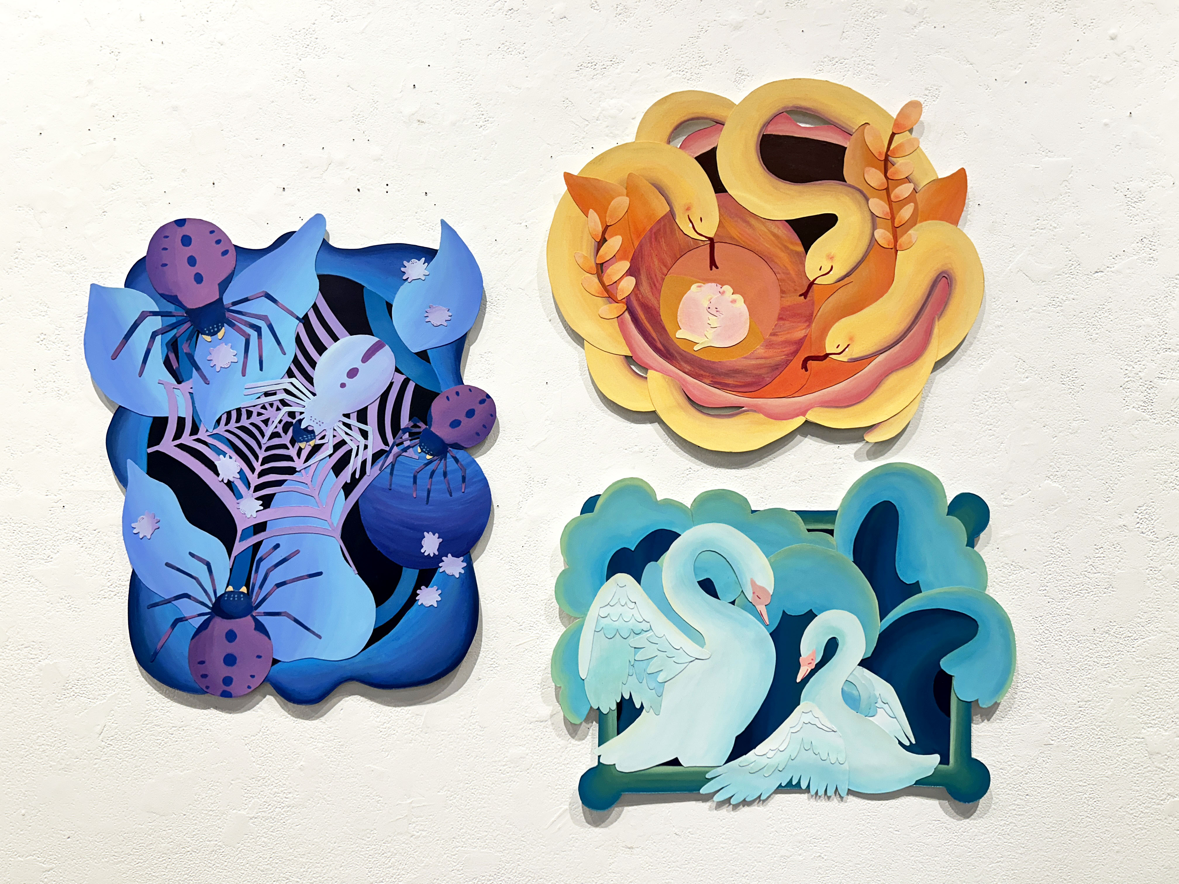 wall with handcrafted depictions of snakes, spiders, and swans