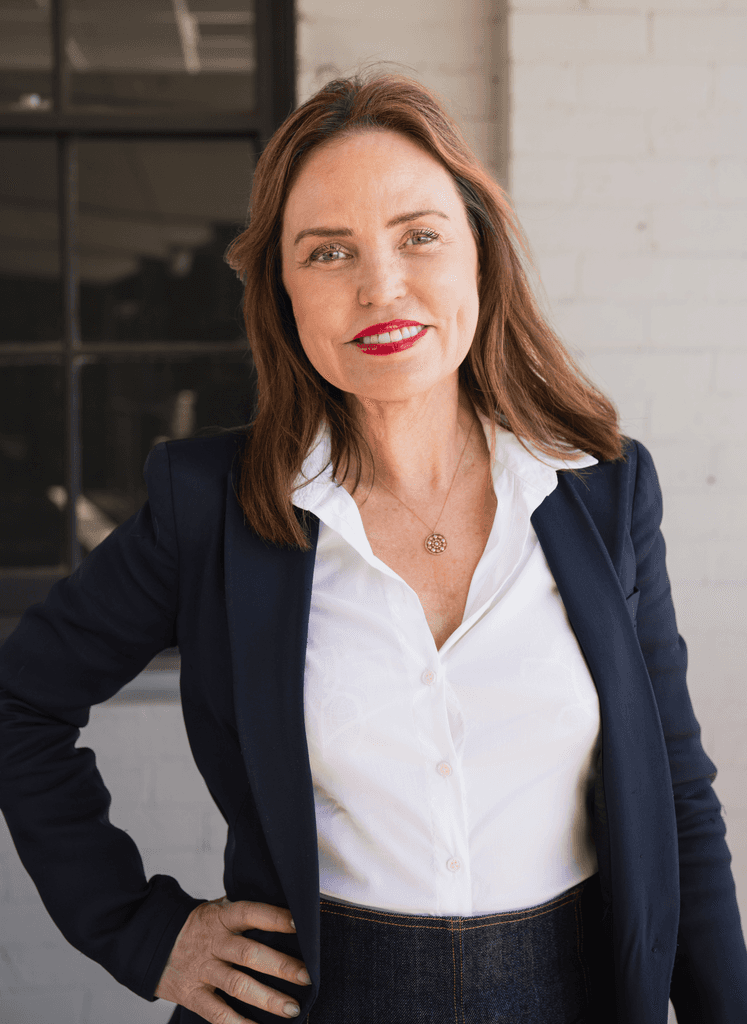 Patricia Stewart, TrialWire CEO, smiling confidently in a navy blazer and white shirt.