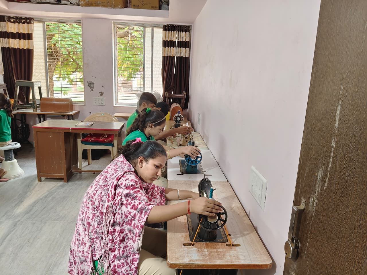 Students learning tailoring skills