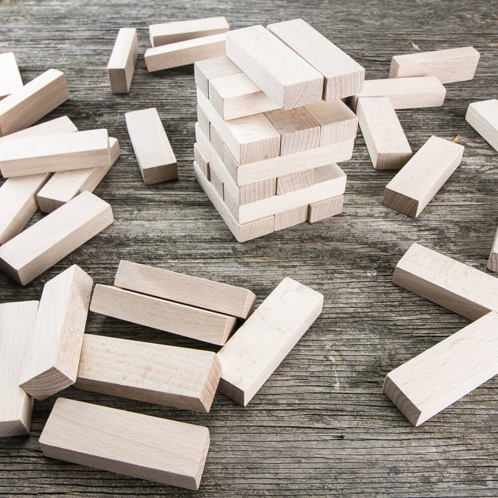 people sitting at the table looking to another person standing in front of them