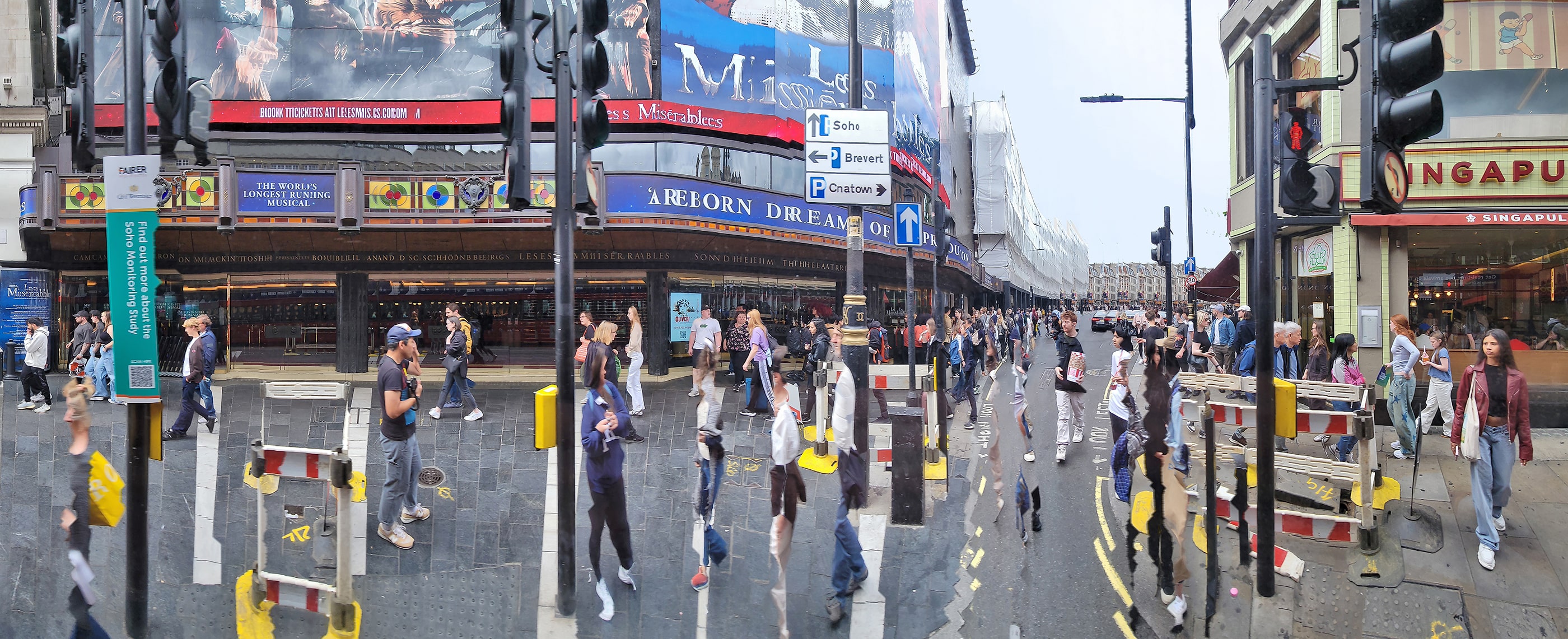 Panoramic street photograph of a busy London intersection near the Sondheim Theatre, showing pedestrians crossing under billboards for Les Misérables. Distorted motion and warped lines create a surreal effect that blurs the boundary between movement and stillness.