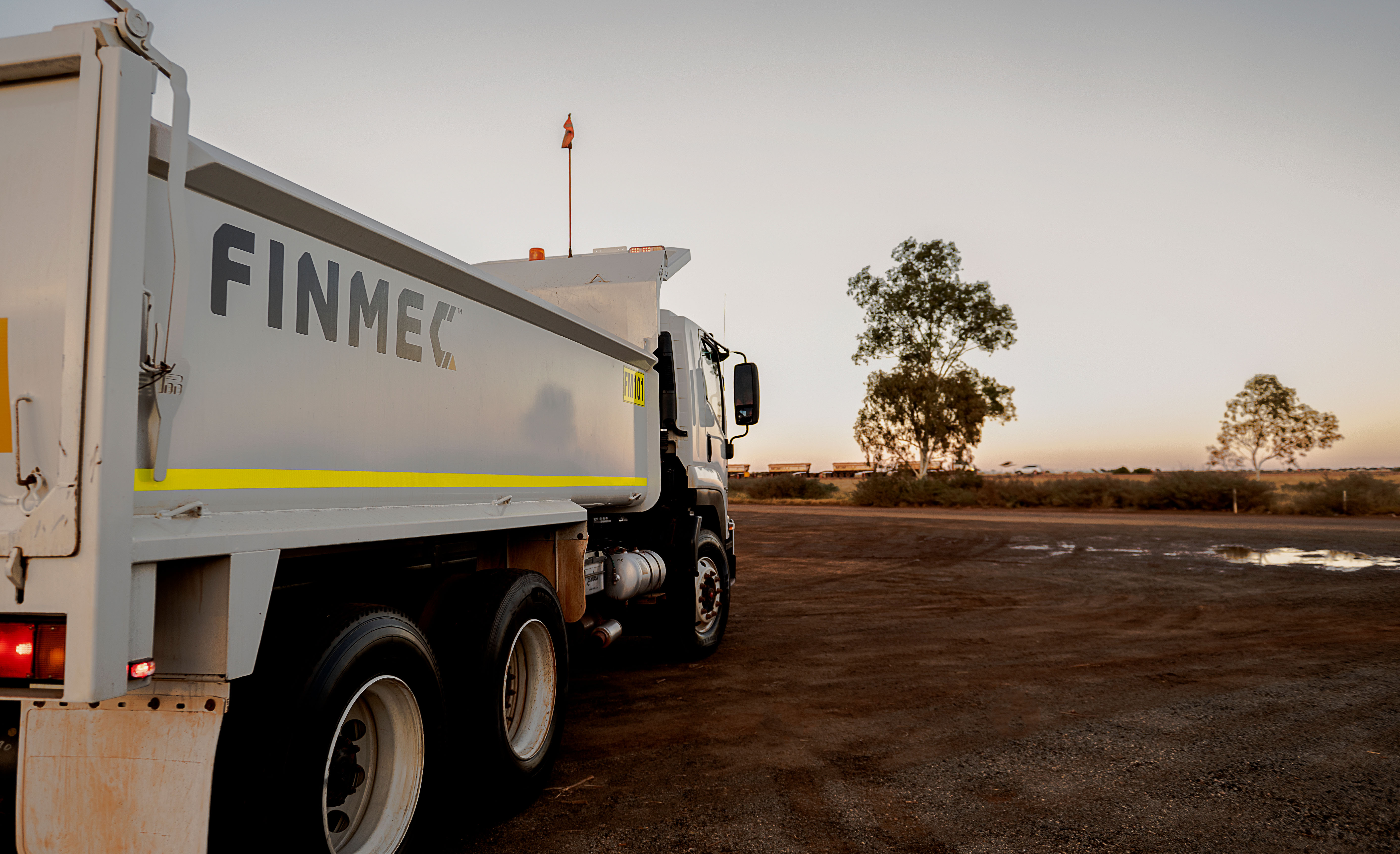 Cluster of translucent pink glass pendant spheres hanging on white—modern lighting décor.
