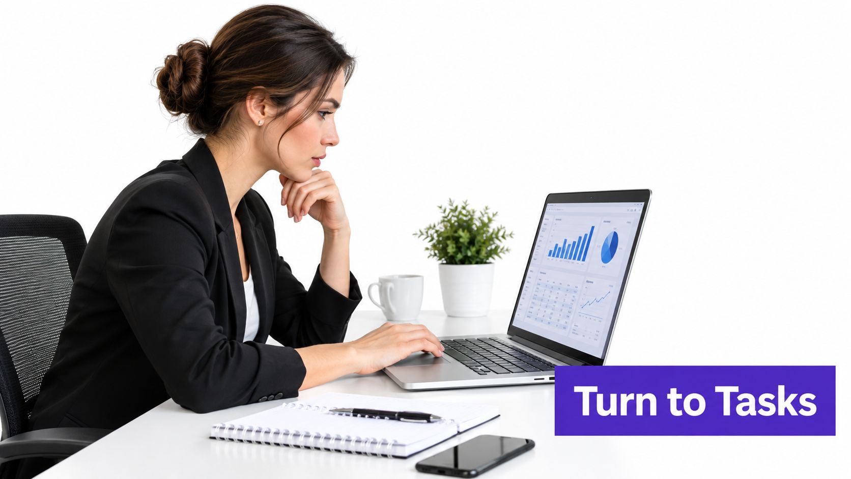 A professional woman in a blazer working on a laptop with data charts displayed on the screen.