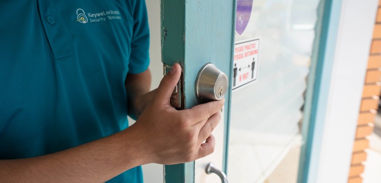 keywe locksmith inspecting a deadbolt