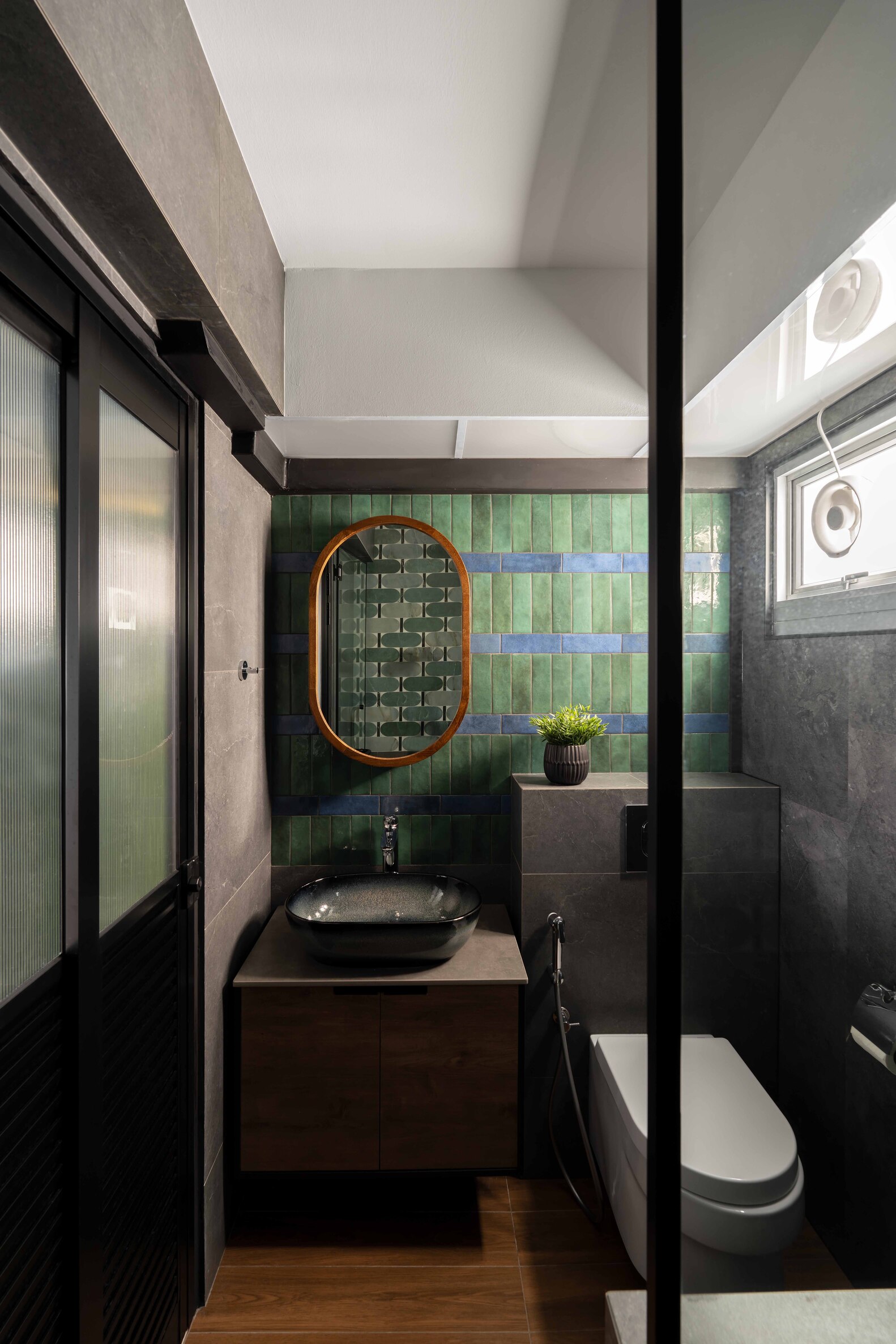 Modern bathroom featuring a sleek design with glass elements and wooden accents, highlighted by a mural.