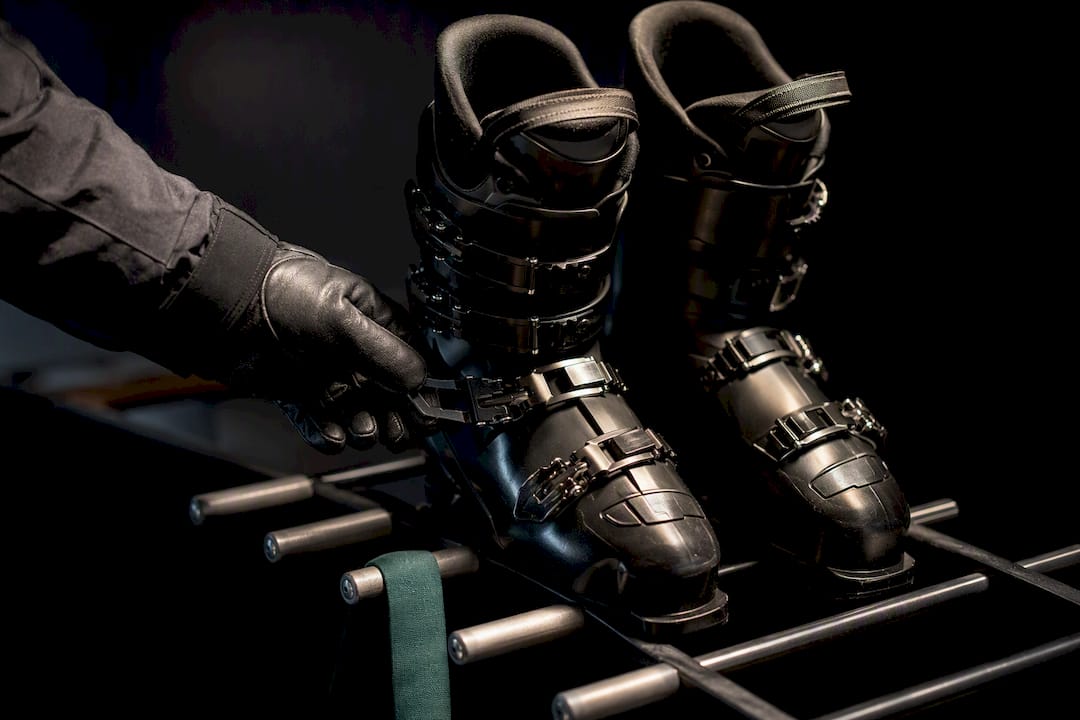 Ski boots positioned on a drying rack