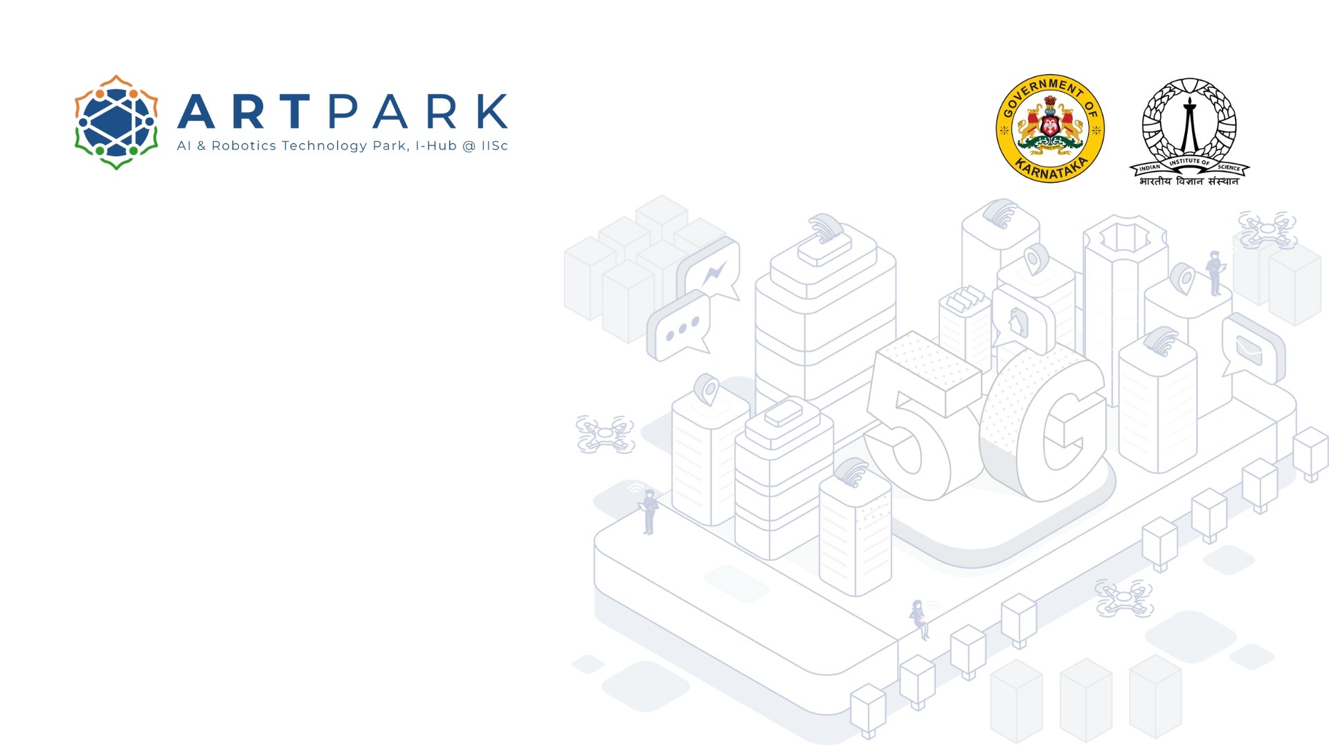 A man stands while two people sit at a table in an office setting, smiling and engaged in conversation. The mood is friendly and collaborative.