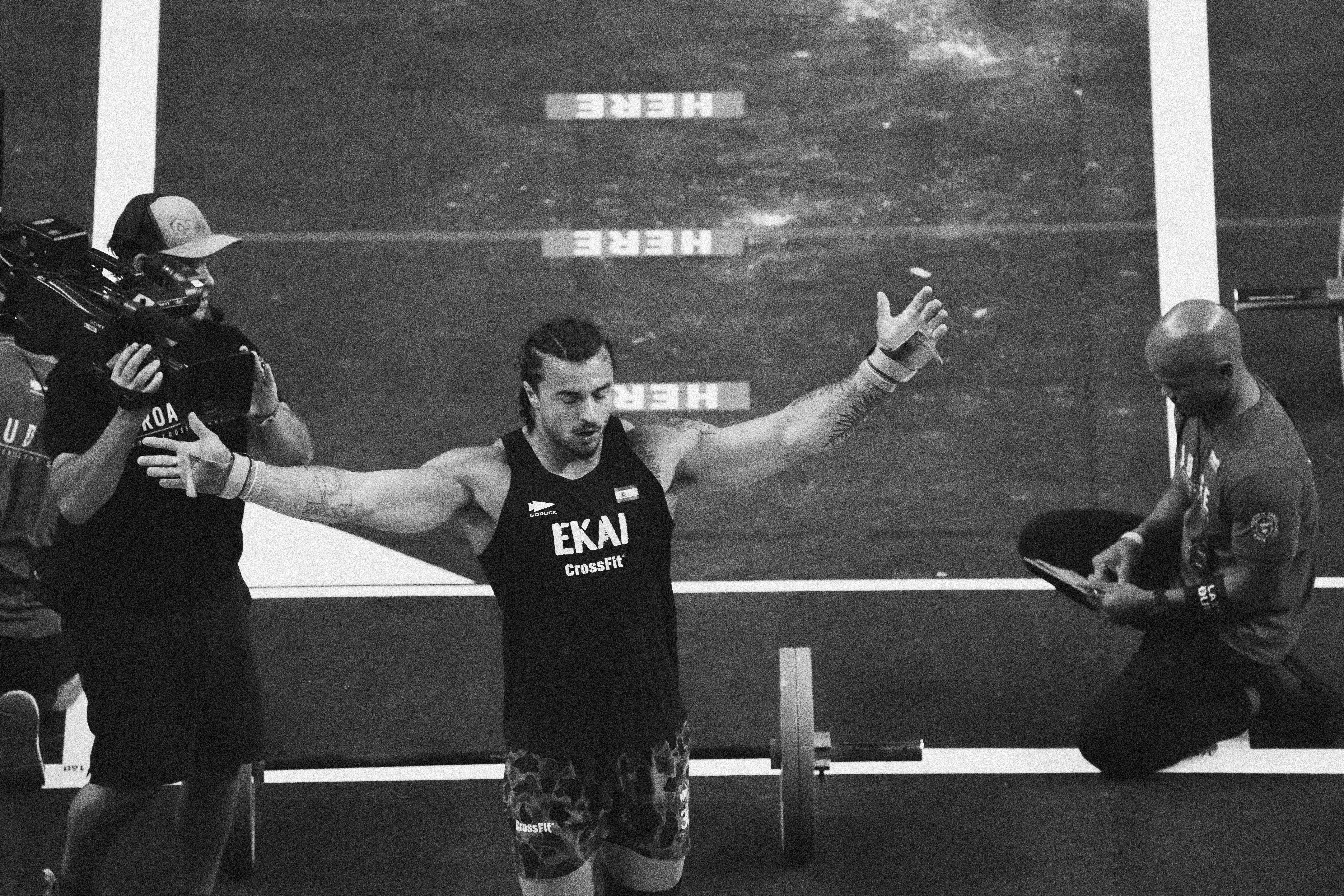 Two men wearing yellow and black face masks, standing side by side, with neutral expressions on their faces.