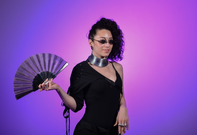 Close-up of vibrant purple flowers with droplets of water, creating a rich, textured background.