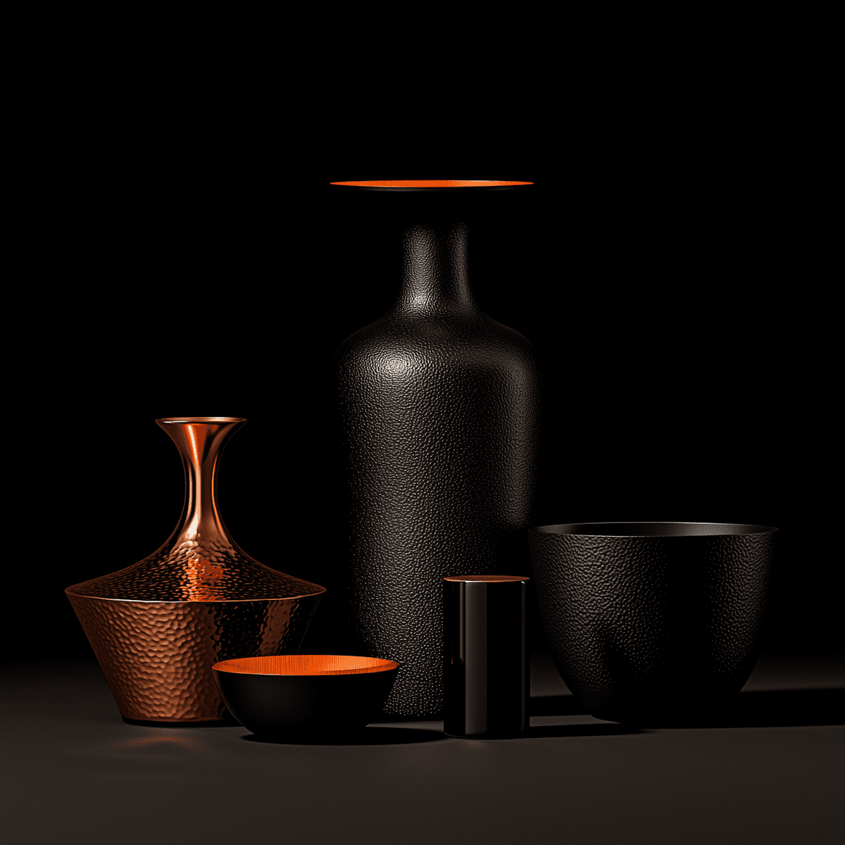 Elegant black and copper vessels with textured surfaces and orange accents, beautifully arranged against a dark background.