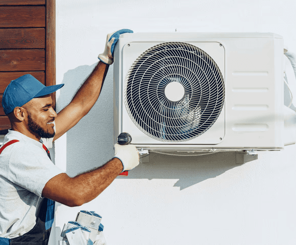HVAC technician installing an outdoor AC unit for a cooling system in a Toronto home