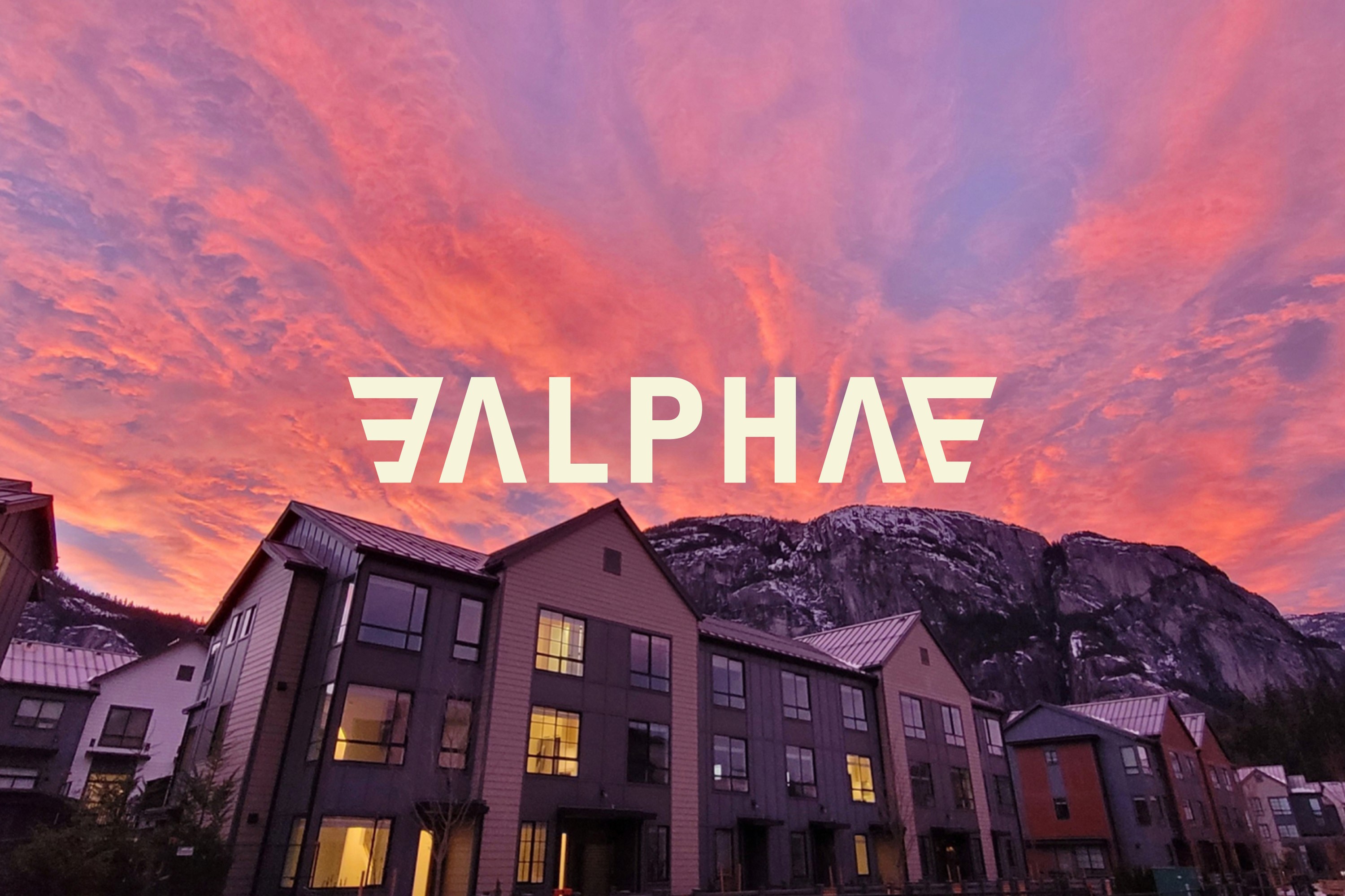 Alpha logo overlayed on an image of a block of flats overlooked by a mountain