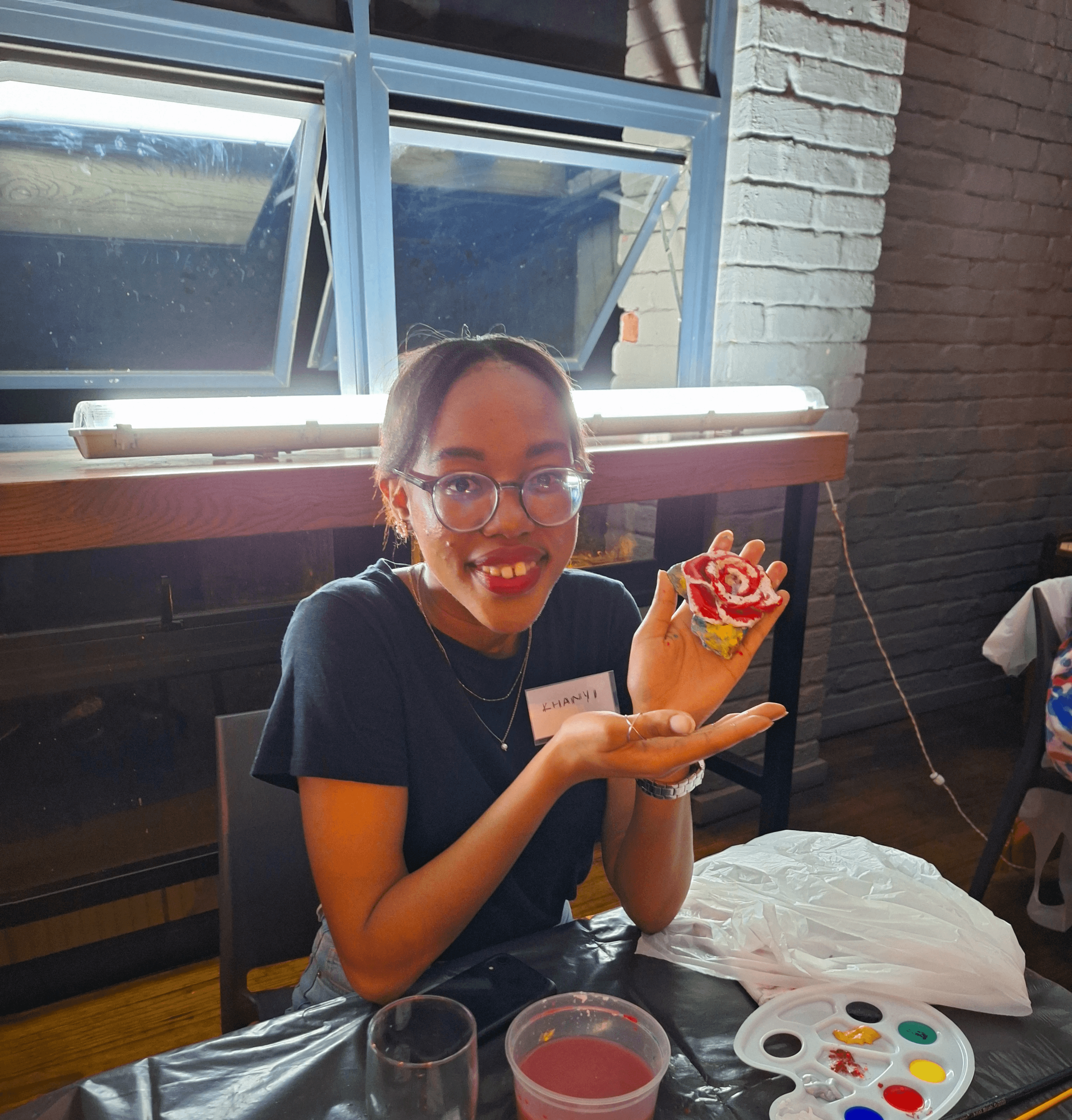 A girl showing her painted artwork