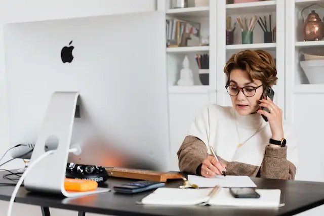 a person on the phone at their desk